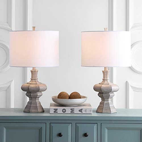 Pair of rustic table lamps with white drum shades on a light blue console.