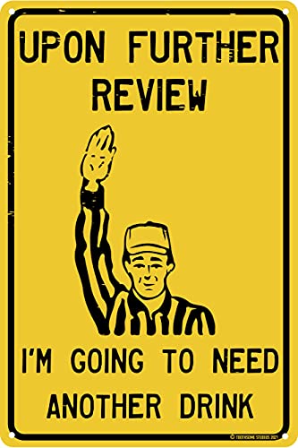 Yellow sign with a referee raising hand and text saying "Upon further review, need a drink"