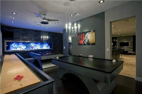 Game room with a pool table, shuffleboard, stylish lighting, and a large wall aquarium