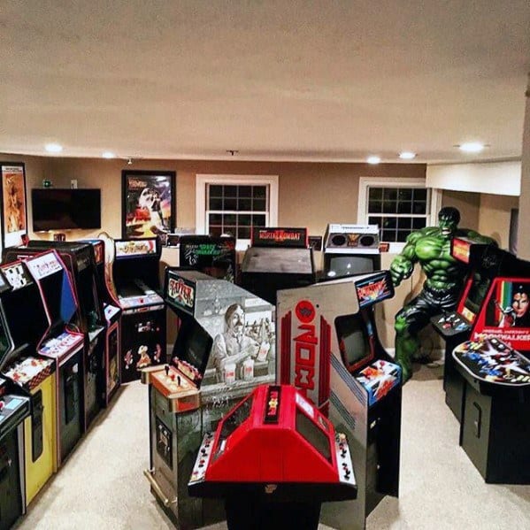 A room filled with retro arcade machines and a large figure of a green superhero in the corner