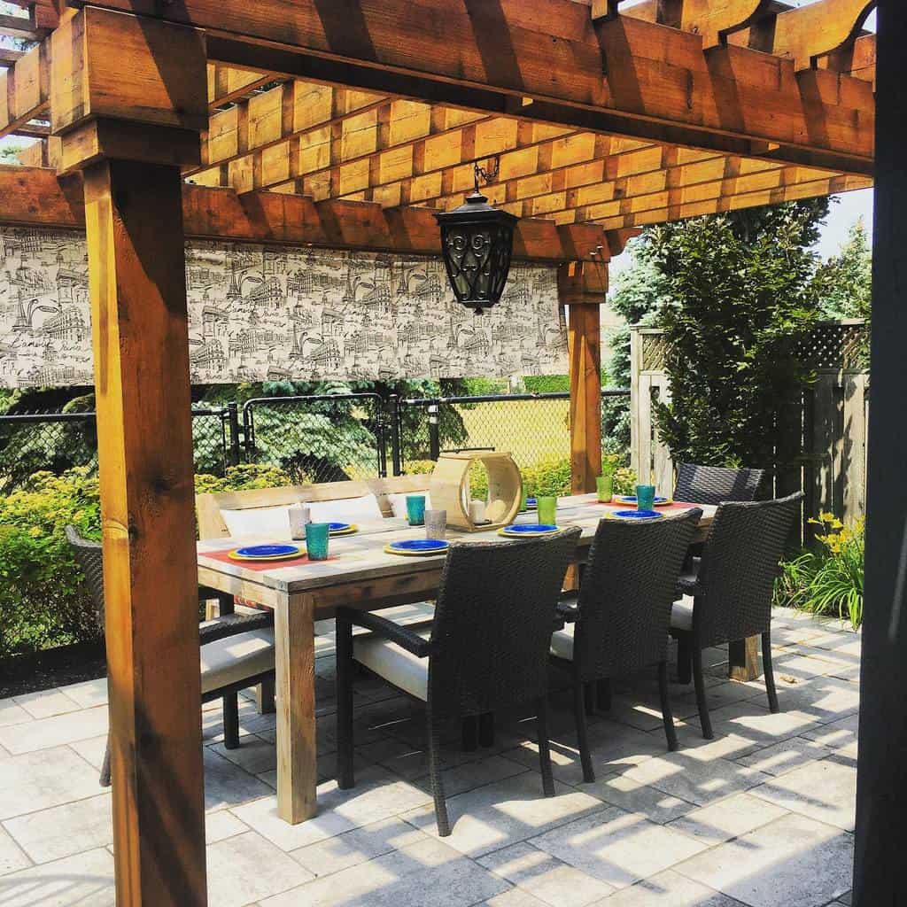 stone paver backyard patio with wood pergola 