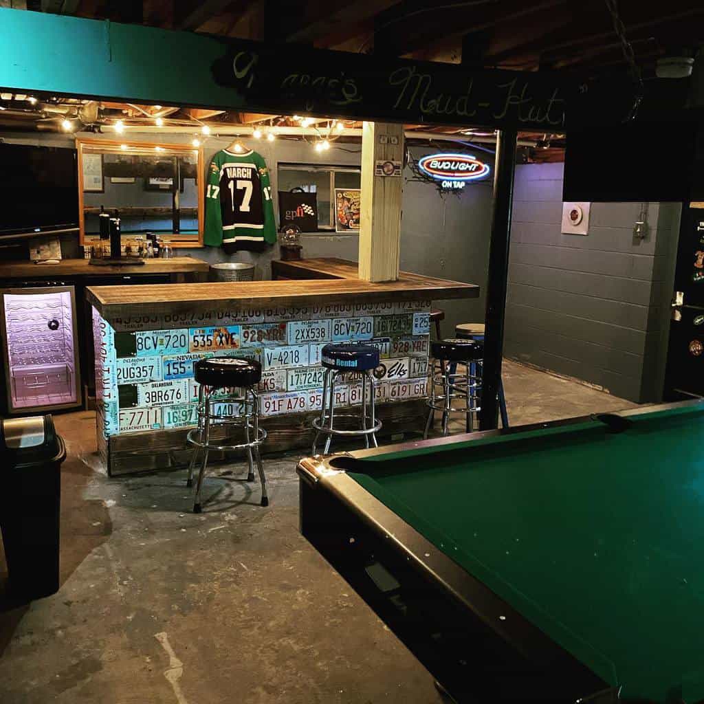 Rustic basement bar with license plate decor, jersey display, neon lights, and pool table.