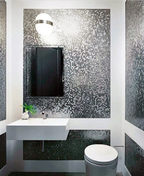 Bathroom with silver mosaic tile backsplash, floating vanity, and modern lighting fixture.