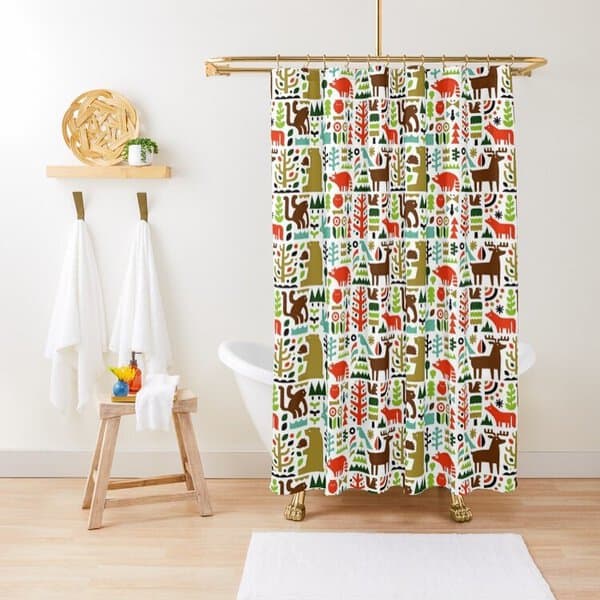 Shower curtain with colorful animal pattern in a minimalist bathroom with white towels.