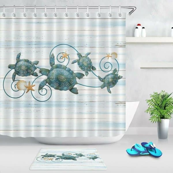 Sea turtle-themed shower curtain with starfish accents in a coastal-style bathroom.