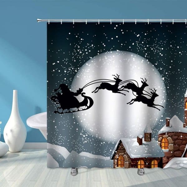 Christmas-themed shower curtain featuring Santa in his sleigh with reindeer flying past a full moon.