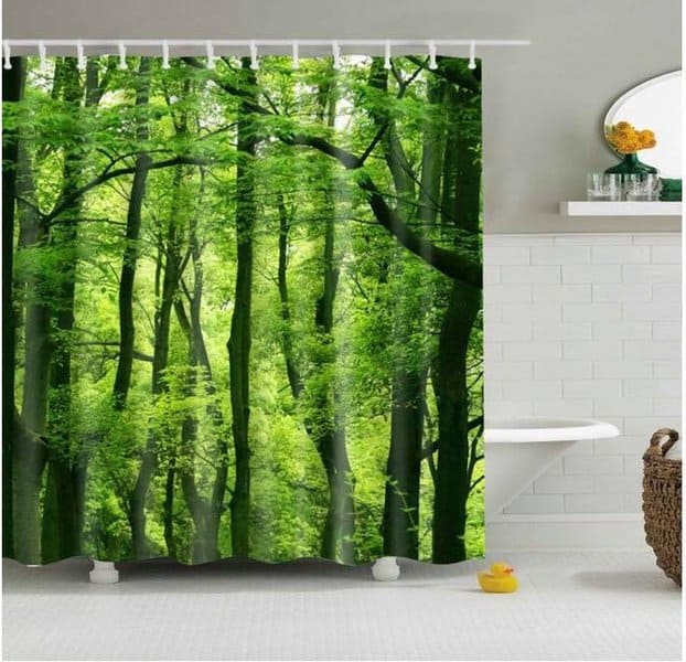 Forest-themed shower curtain in a white modern bathroom with greenery accents.