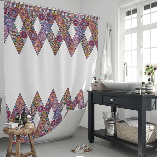 Bohemian-style shower curtain with geometric patterns in a bright bathroom with black vanity.