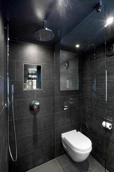 Black granite tile shower with rainfall showerhead, recessed niche, and wall-mounted toilet.