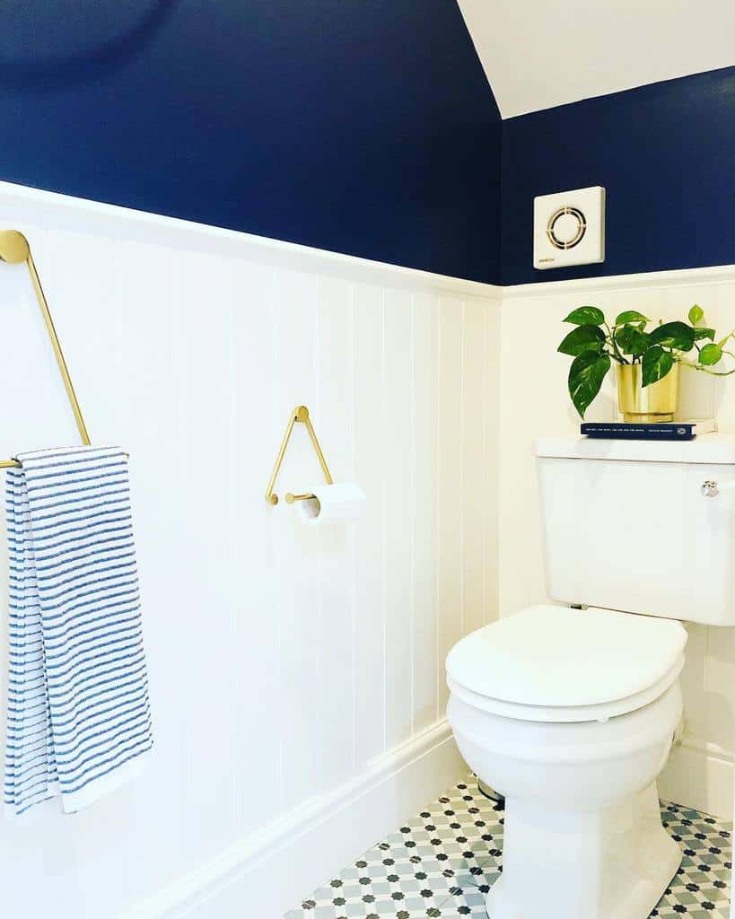 bathroom white wall paneling blue wall toilet 