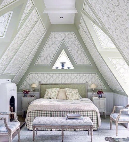 A cozy attic bedroom with a triangle window, patterned walls, a bed, chairs, and a bench in soft pastel shades