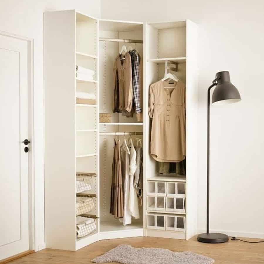 Corner closet with hanging space, shelves, storage bins, and a floor lamp.