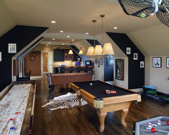 Game room with pool table, shuffleboard, dartboard, zebra rug, and bar area, decorated with framed pictures