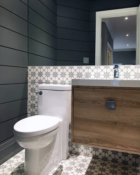 Contemporary bathroom with grey shiplap walls, patterned tile backsplash, and floating vanity.