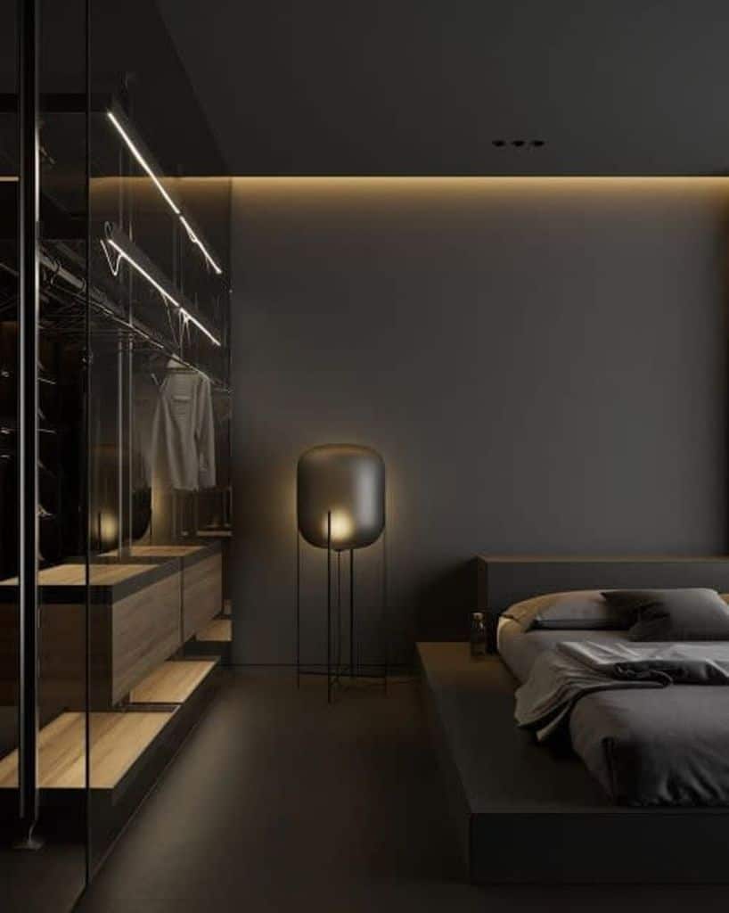 Modern dark bedroom with platform bed, ambient lighting, and glass wardrobe.