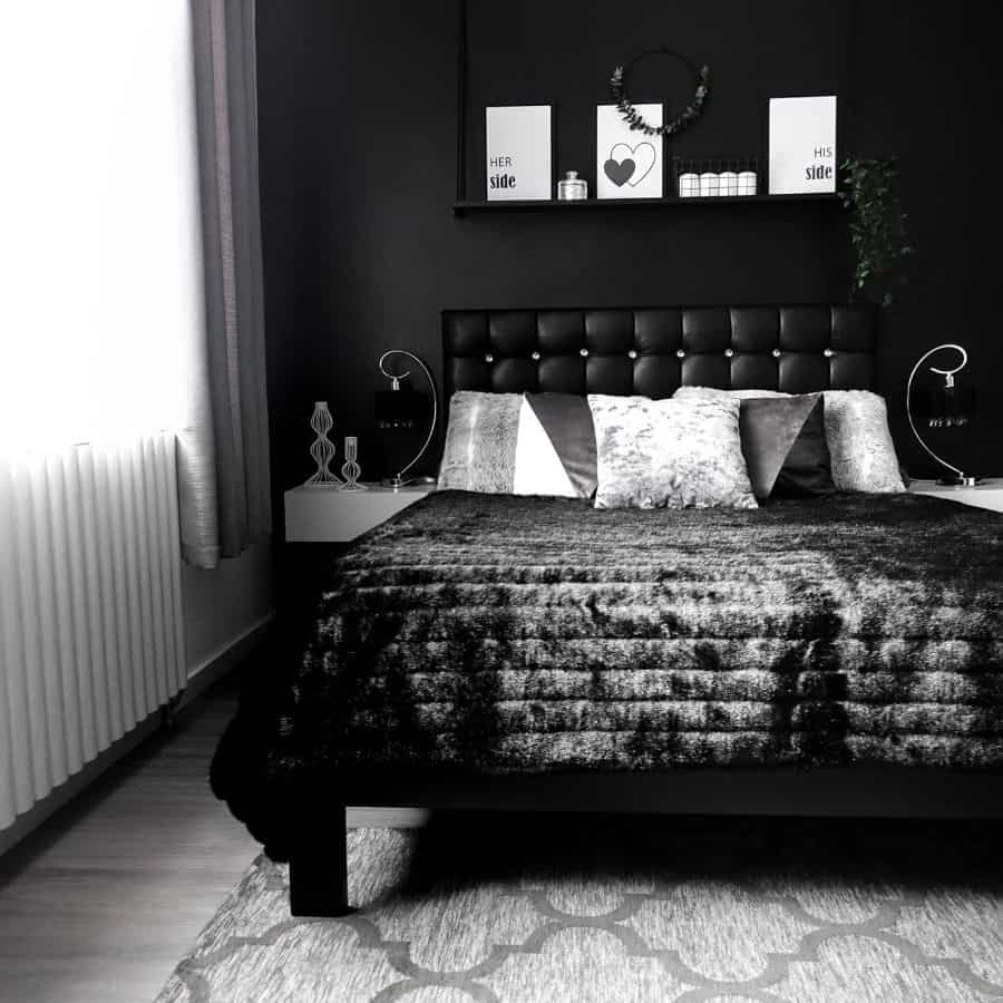 Black and white bedroom with tufted headboard, plush bedding, and minimal decor.