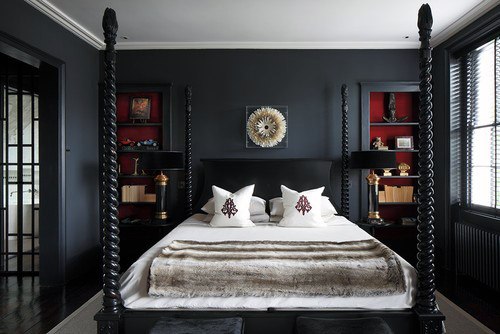 Elegant black bedroom with four-poster bed, red shelving accents, and cozy fur bedding.