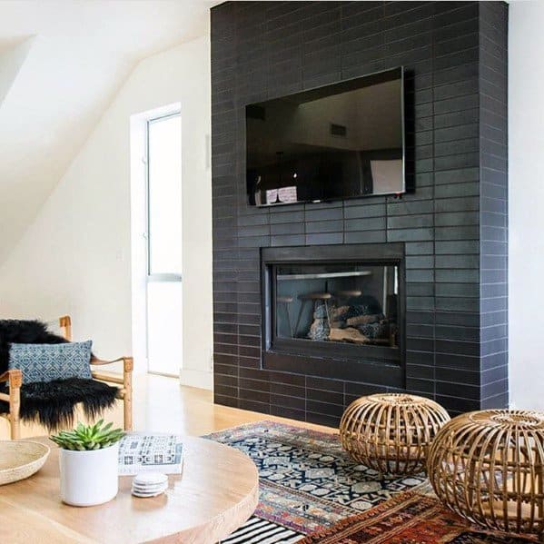 Modern living room with black subway-tiled fireplace and mounted TV above.