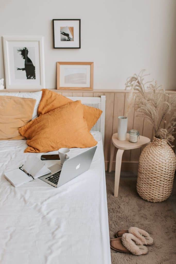 Cozy boho bedroom with earthy tones, framed art, and natural textures.