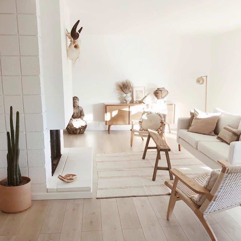 Bright boho-inspired living room with natural wood furniture, neutral tones, a cactus, and warm sunlight accents