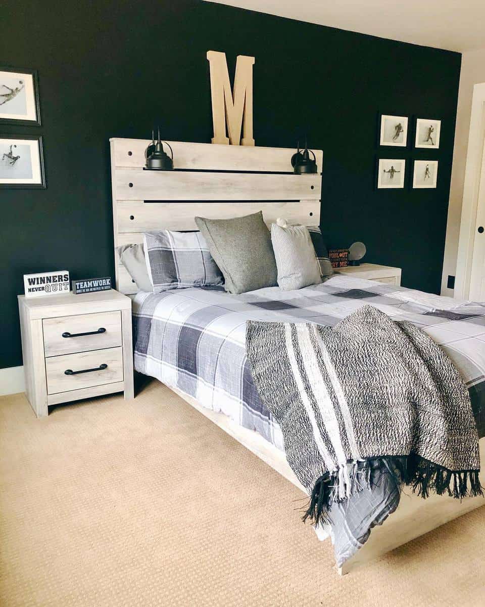 Modern bedroom with a plaid bedspread, wood headboard, pillows, and a cozy throw. Wall art and a large "M" on display