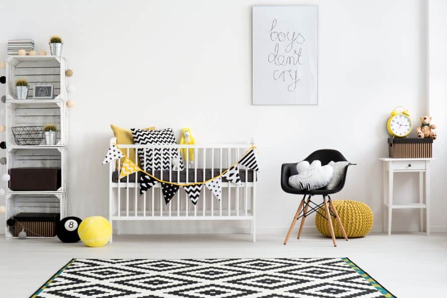 Stylish baby boy's room with black, white, and yellow decor and geometric accents.