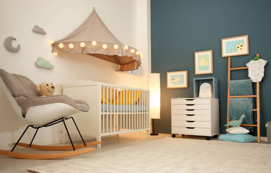 Adorable baby boy's room with crib, cloud-themed wall decor, and warm lighting details.