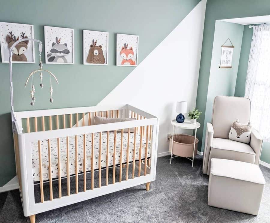 Adorable baby boy's room with woodland animal prints, white crib, and soft green accents.