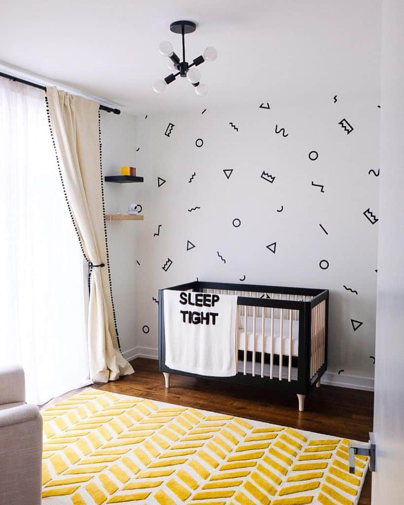 Modern baby boy's room with abstract wallpaper, black crib, and bold yellow rug.