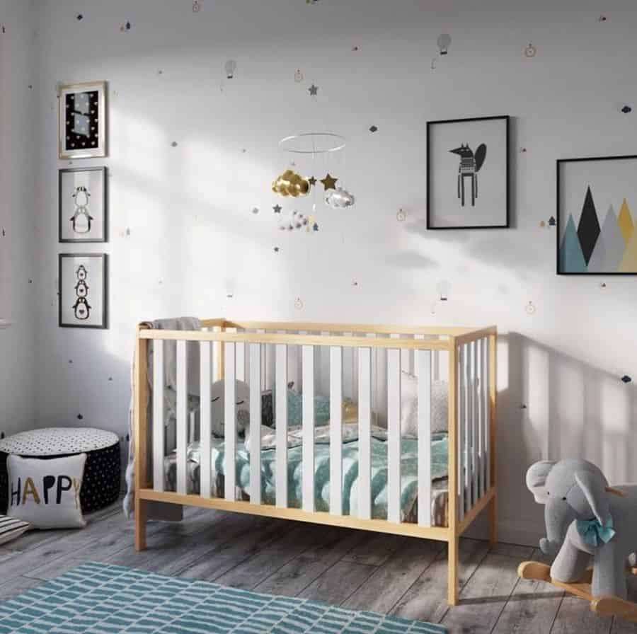 Scandinavian-style baby boy's room with light wood crib, playful wall art, and cozy decor.