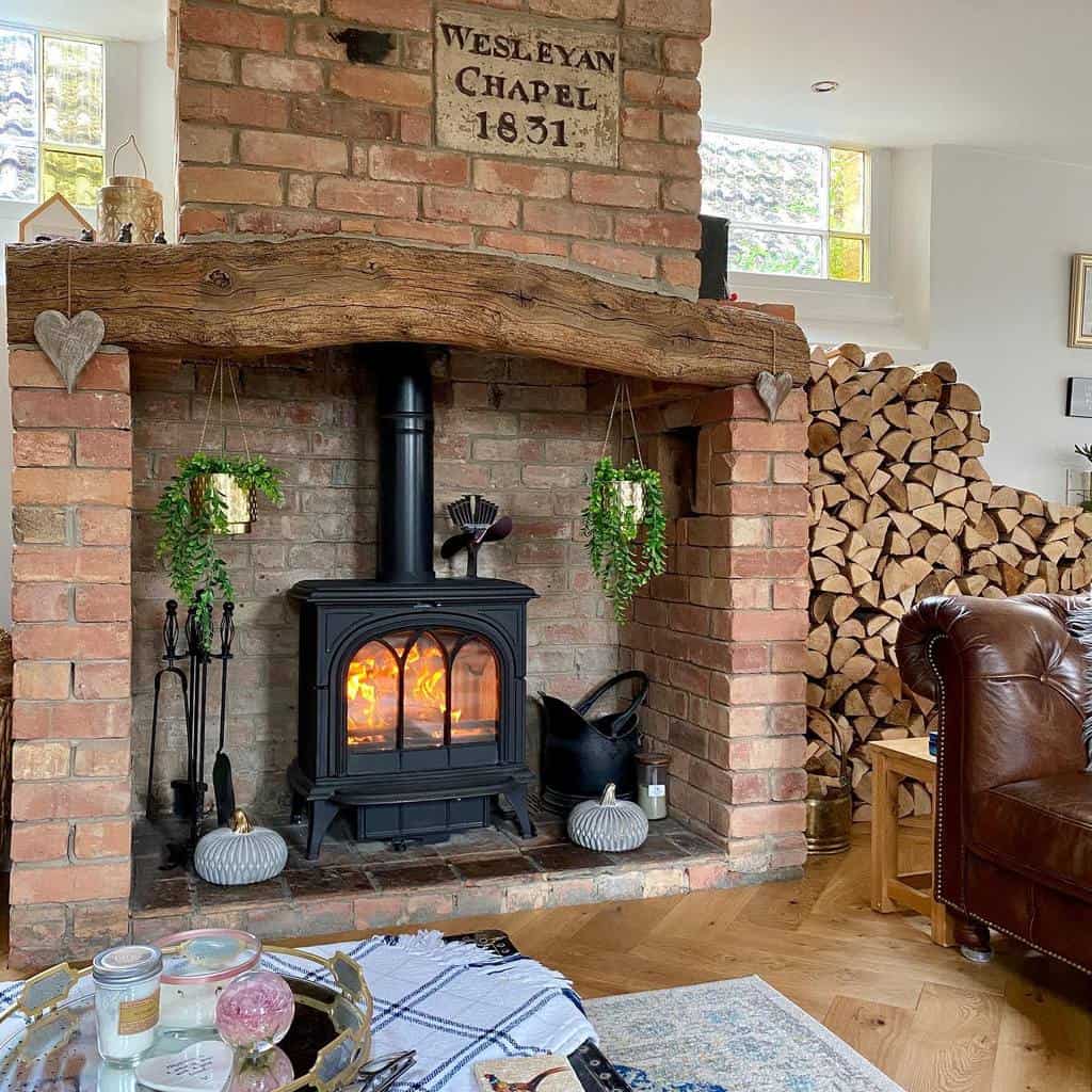 old red brick fireplace wood log mantle stacked firewood 