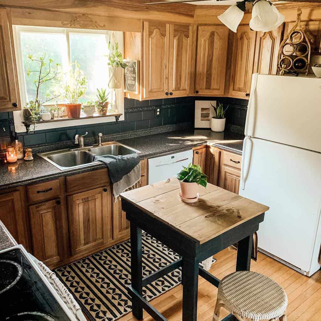 rustic kitchen wood cabinets granite countertop small wood table and wicker chair 