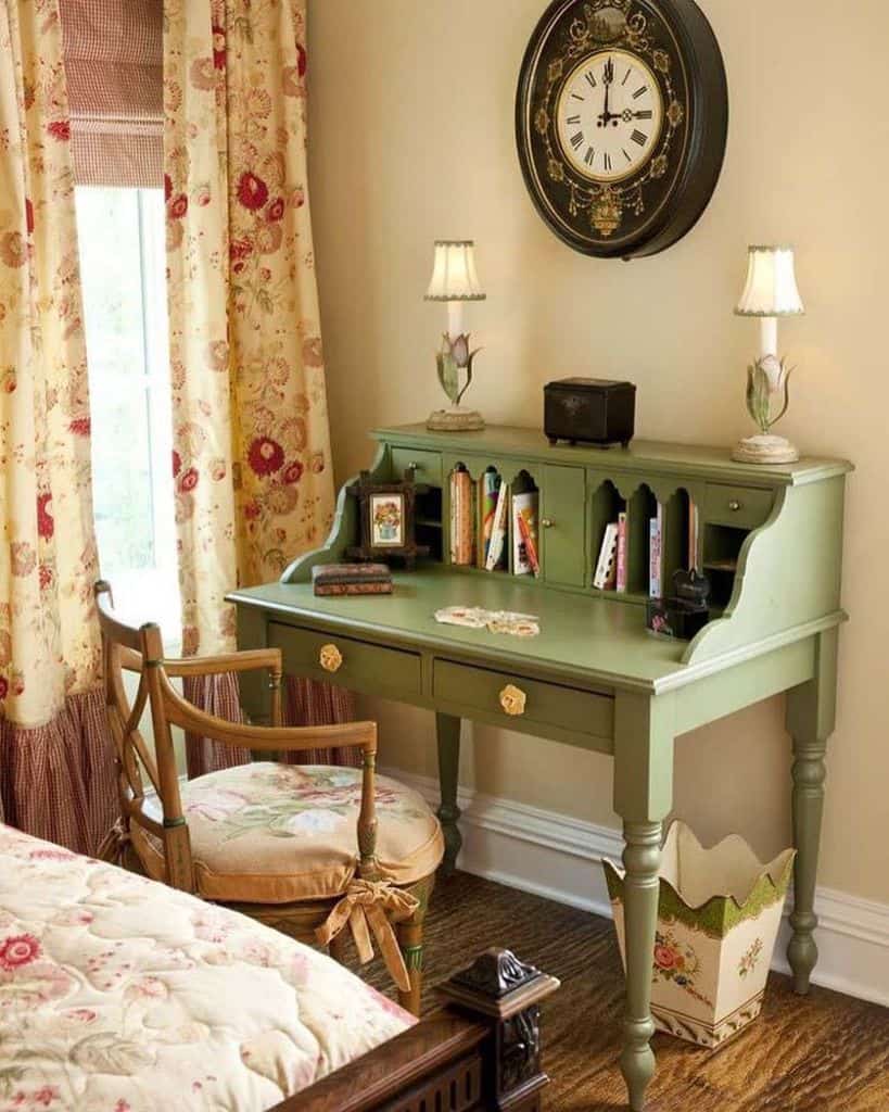 Vintage green desk with floral decor, classic chair, and wall clock in cozy room.