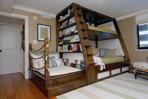 Rustic timber bunk bed with built-in bookshelves and cozy seating area.