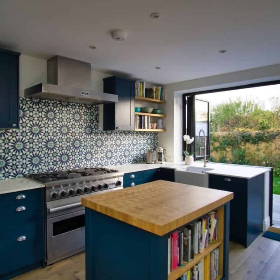 blue cabinet kitchen with butcher block countertop island 