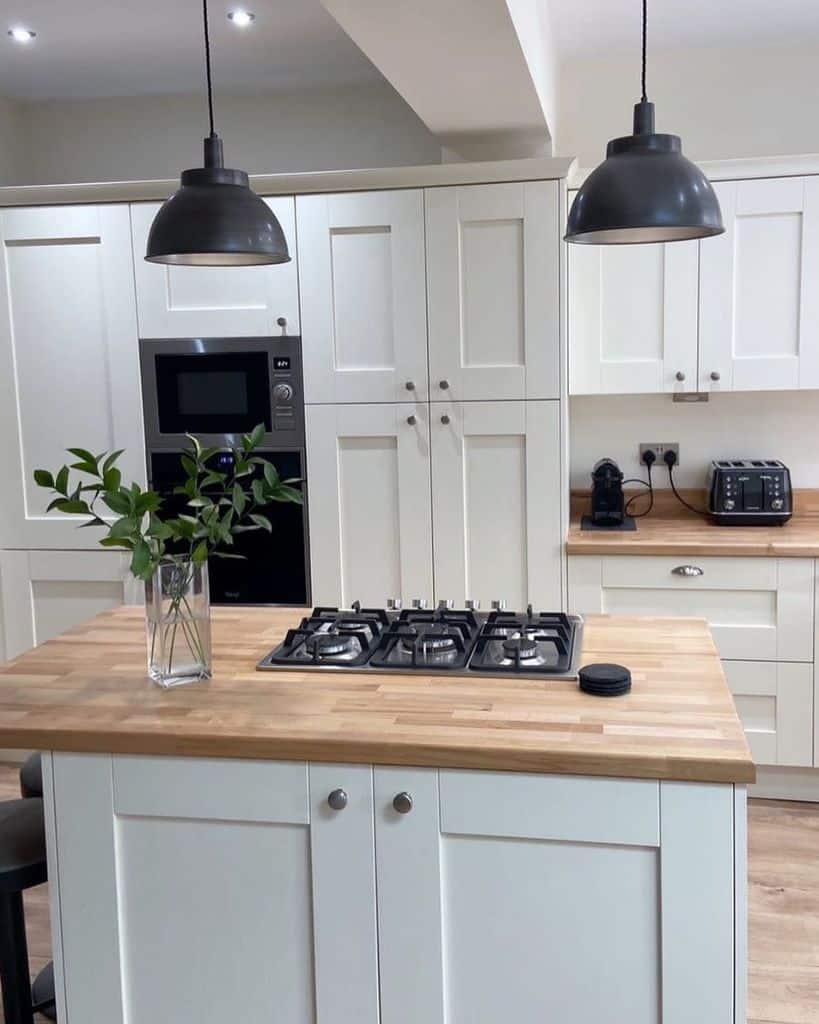 white cabinet kitchen with butcher block countertops 