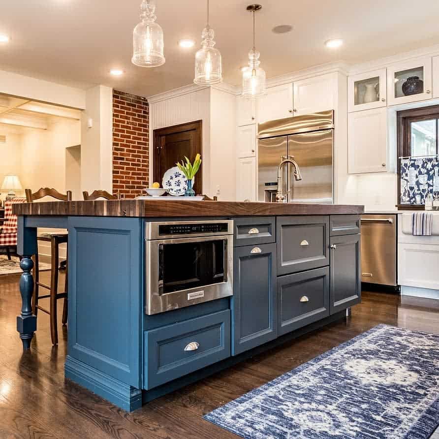 white cabinet kitchen blue cabinet island wood countertop 