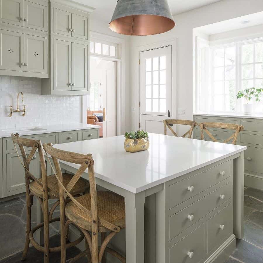 pale green cabinet kitchen with white marble countertops 