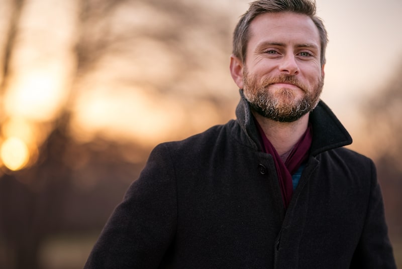 Caucasian,Gentleman,Wearing,A,Pea,Coat,And,Maroon,Scarf,Positioned