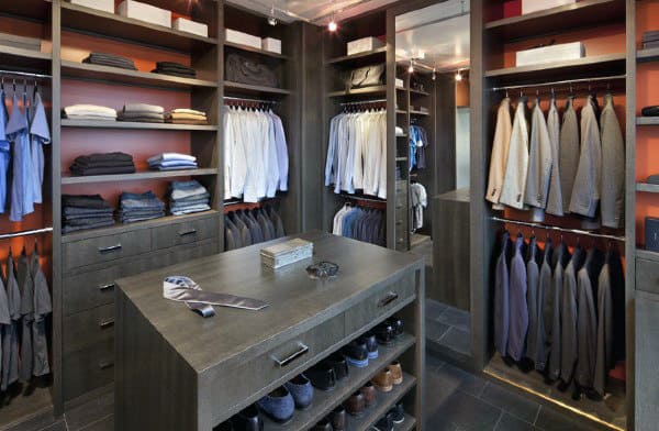 Walk-in closet with neatly arranged shirts, jackets, shoes, and accessories on shelves and racks