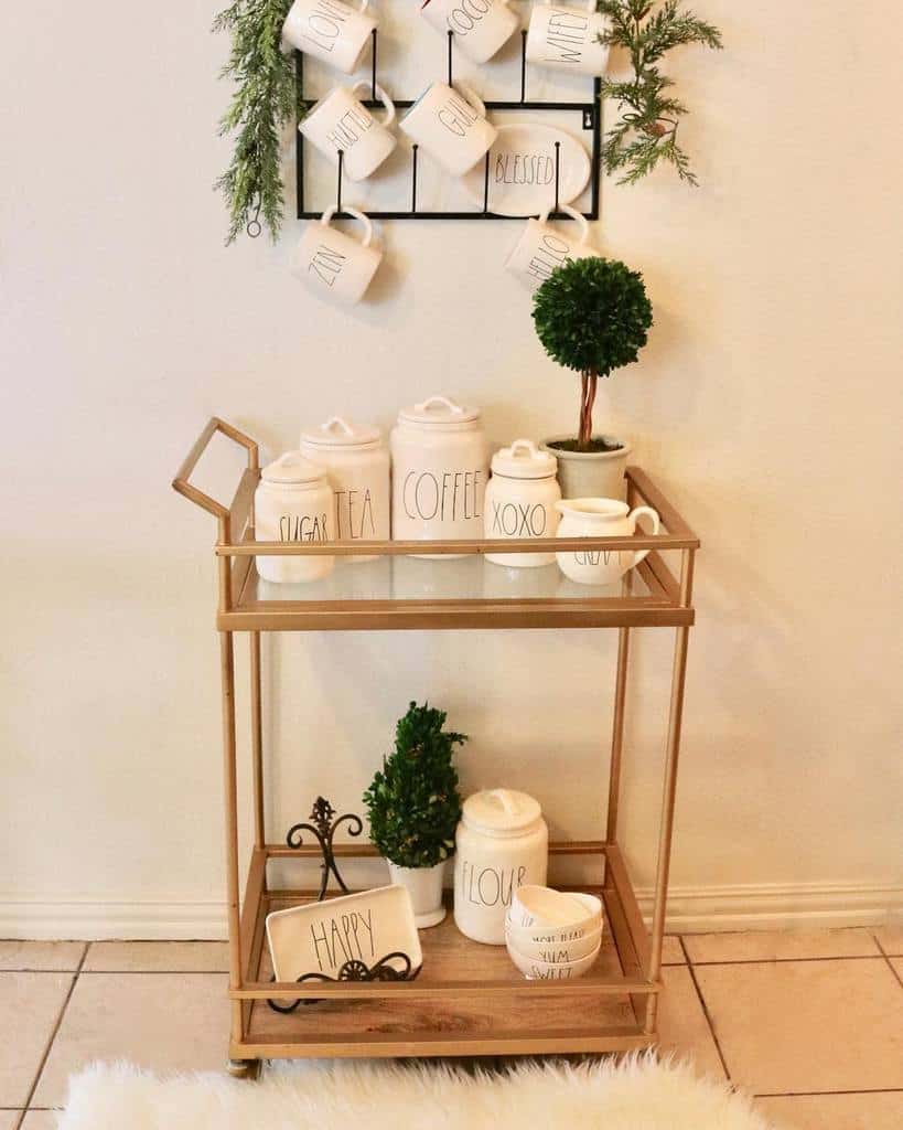 Rustic coffee bar cart with Rae Dunn mugs, canisters, and small topiary accents.