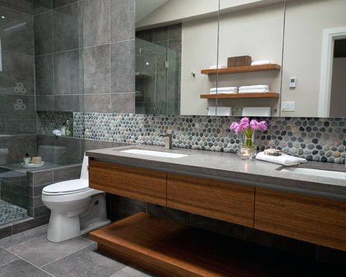 Bathroom with mosaic tile backsplash, floating wood vanity, and walk-in shower.