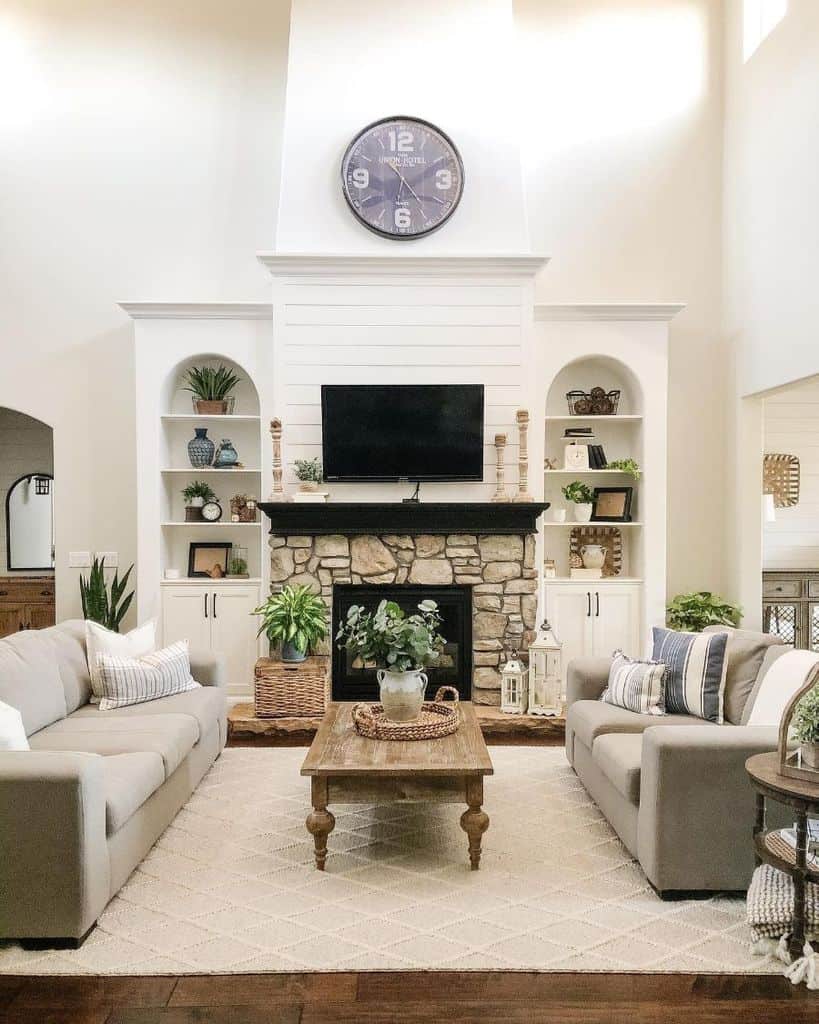 contemporary living room stone fireplace gray couch shiplap wall 