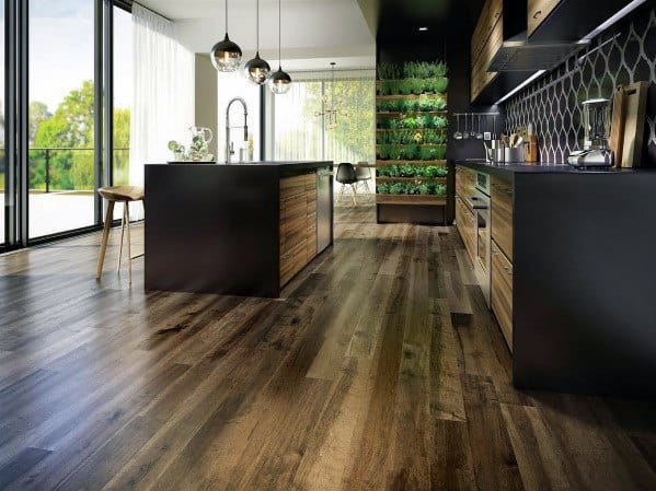 Modern kitchen with dark hardwood flooring, sleek black and wood cabinetry, and large windows offering natural light