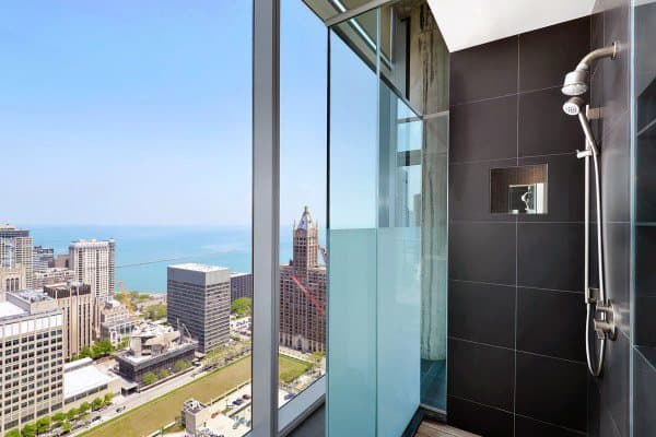 Relax in the shower with a sweeping view of the city skyline and lake under a clear blue sky