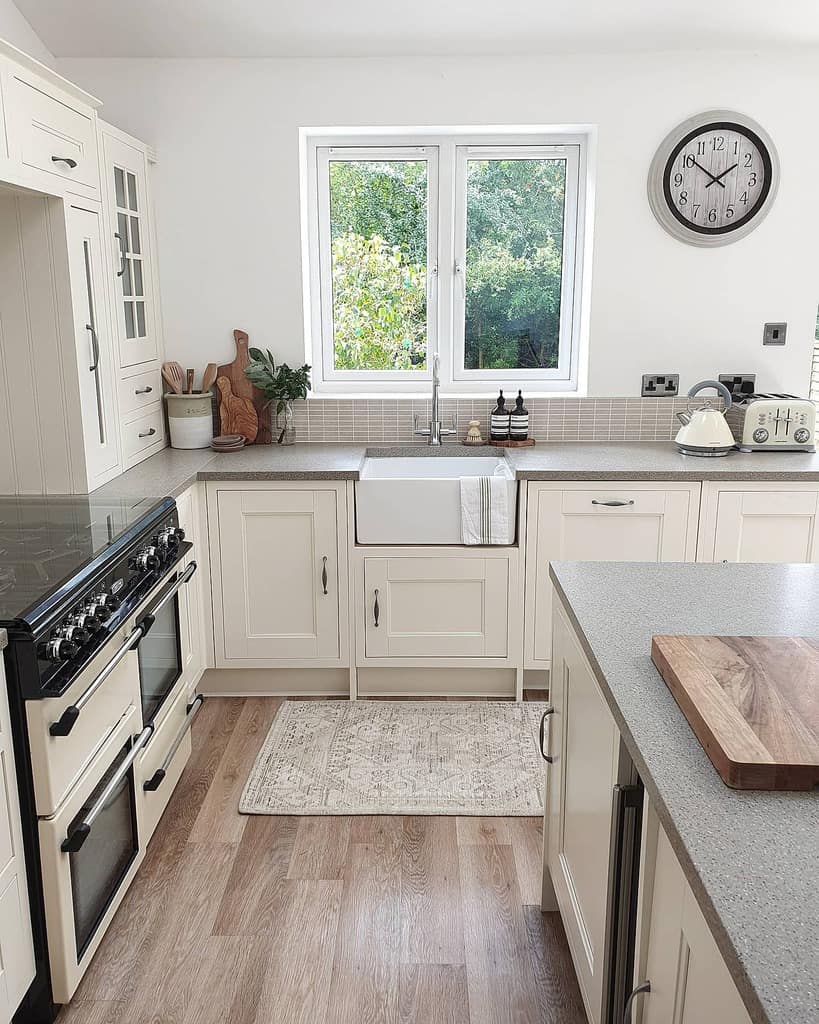 white kitchen cabinets and apron sink gray countertops 