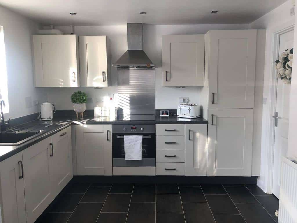 white cabinet corner kitchen black tile flooring 