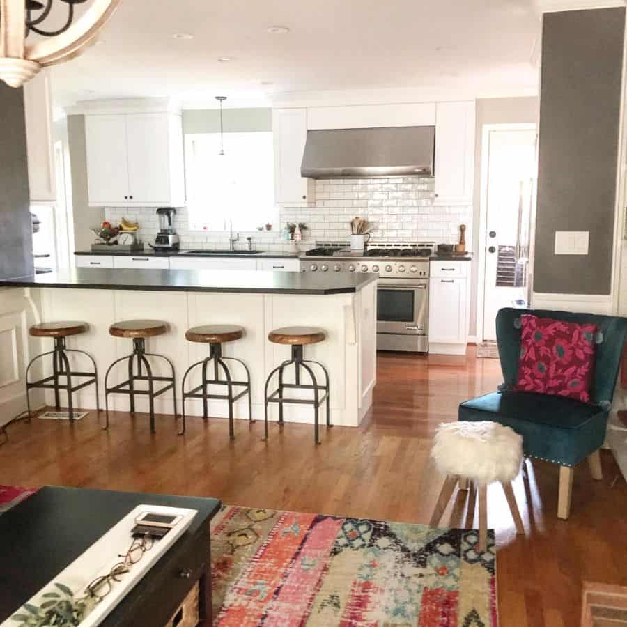 white kitchen bar white subway tiles wood floor 