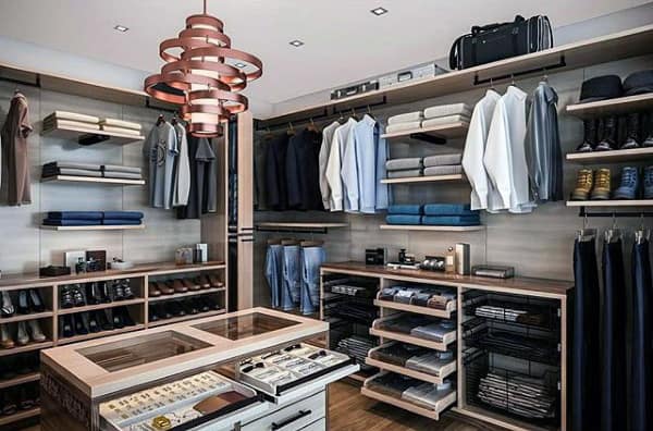 Modern walk-in closet with neatly arranged clothes, shoes, and accessories on shelves and racks