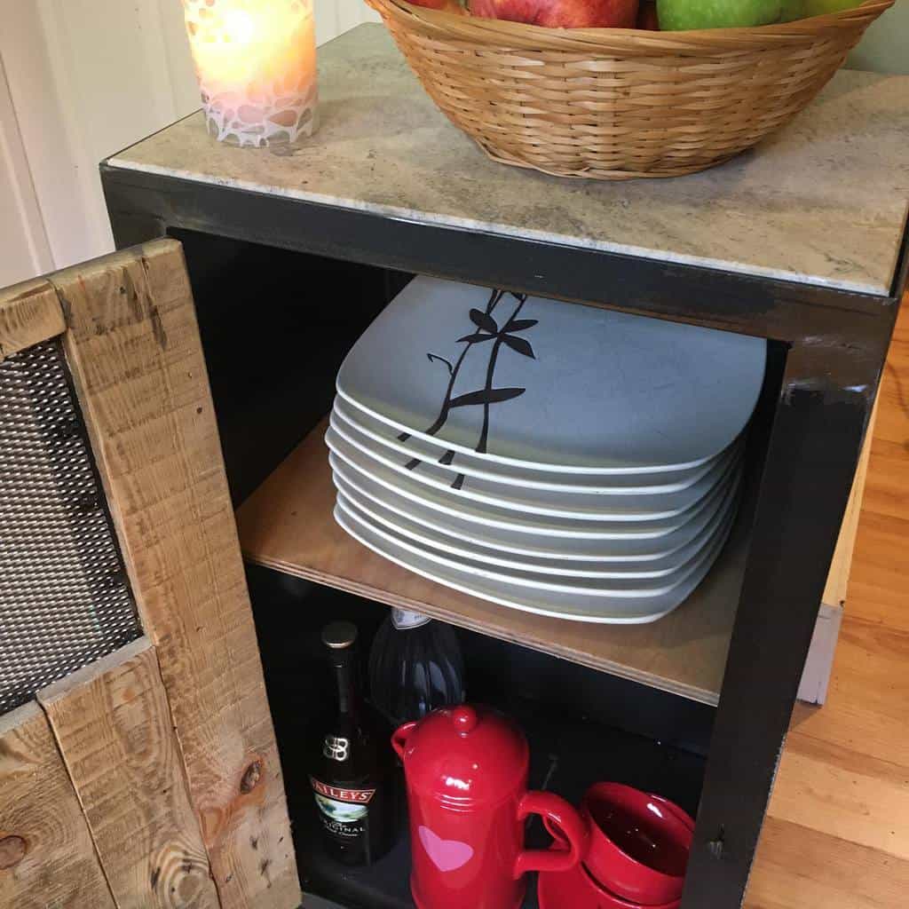 small kitchen cupboard with white plates and red tea set